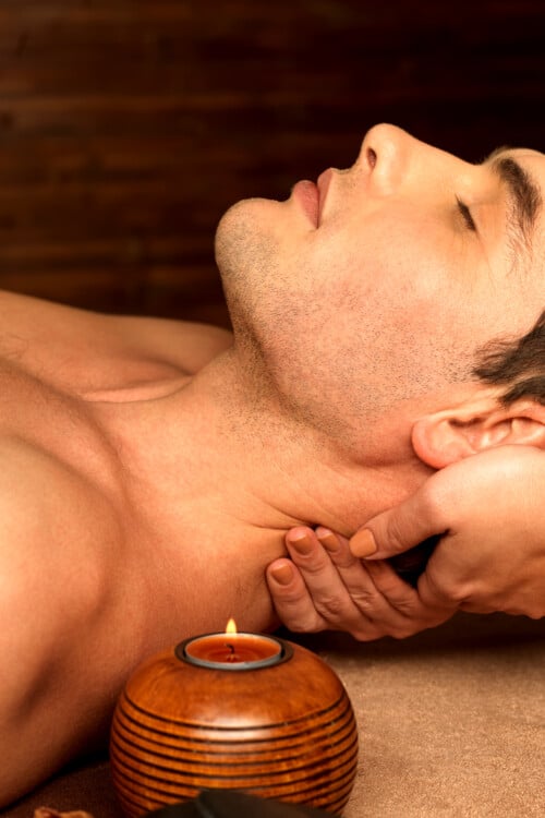 man having neck massage in the spa salon