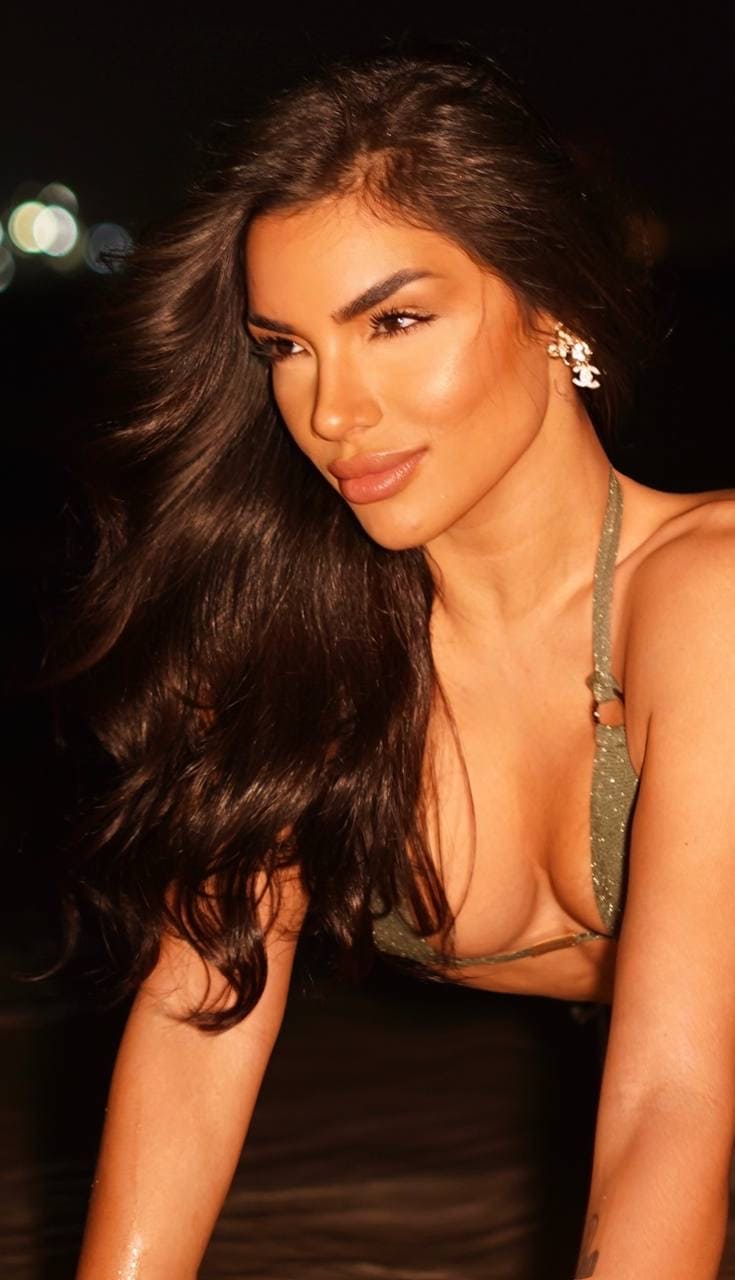 Portrait of a woman with long dark hair at night.