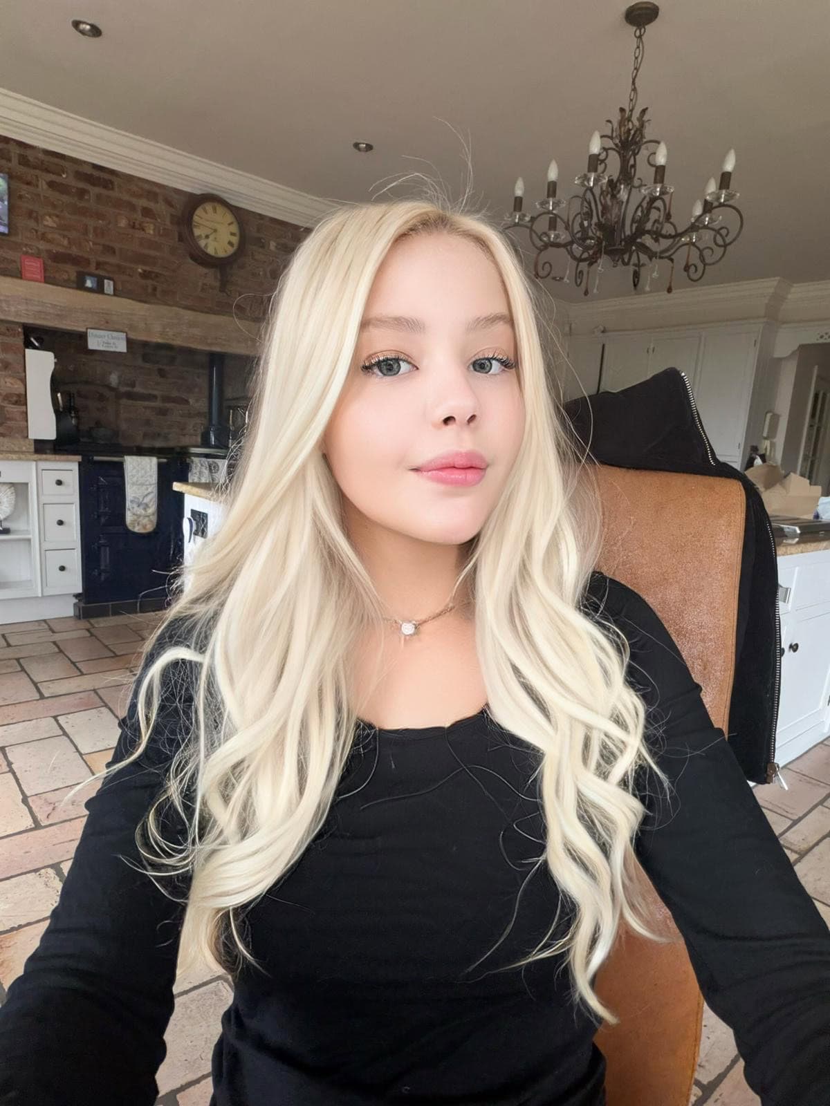 Young woman with long, wavy platinum blonde hair.