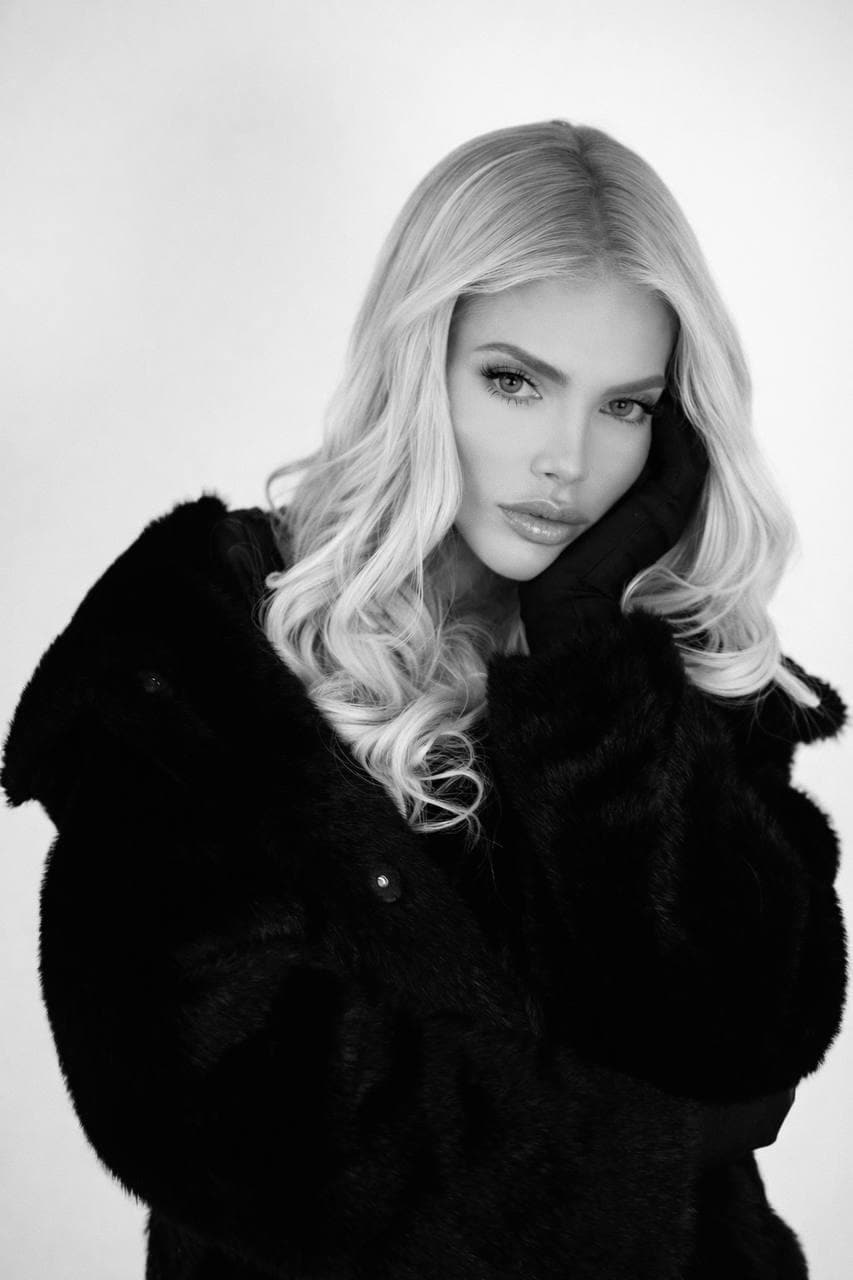 Monochrome portrait of a woman wearing a dark fur coat.