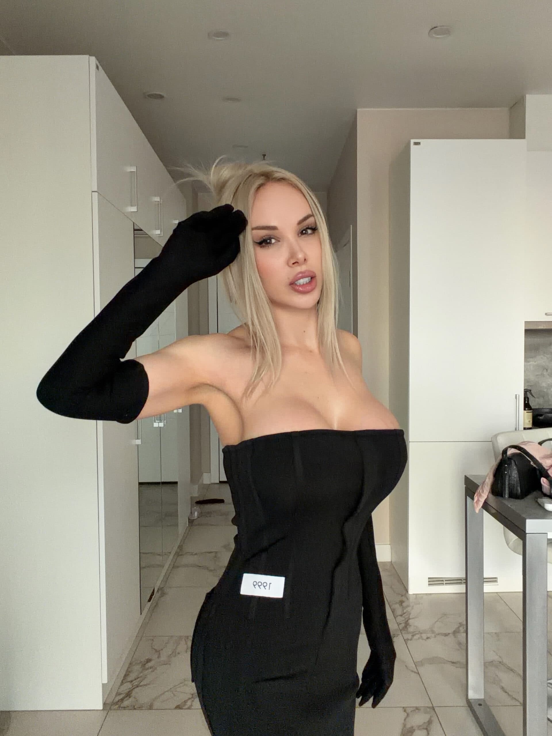 Woman in black strapless dress and long black gloves.